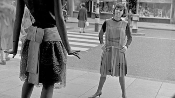 Quant: Black and white image of woman looking into shop window