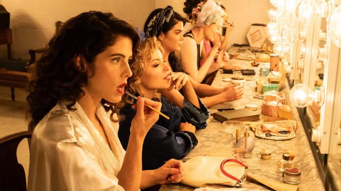 Queen of the Ring movie: Emily Bett Rickards puts makeup on at a vanity counter