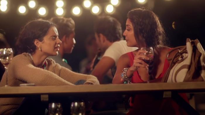 Queen: Two Indian women share a conversation while drinking.