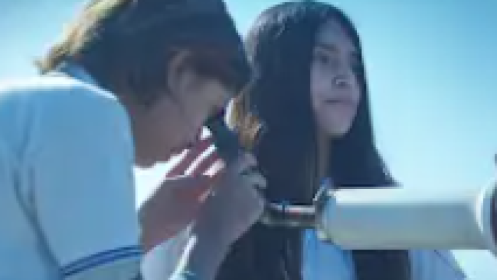 Radical Movie: Nico and Paloma, in school uniforms, look through a homemade telescope