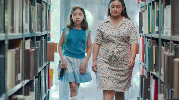 Radical Movie: Lupe and the librarian walk through the aisles of the public library