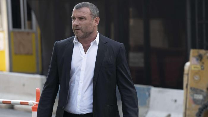 Ray Donovan: The Movie: Liev Schreiber in a dark suit and white shirt stares into the distance.