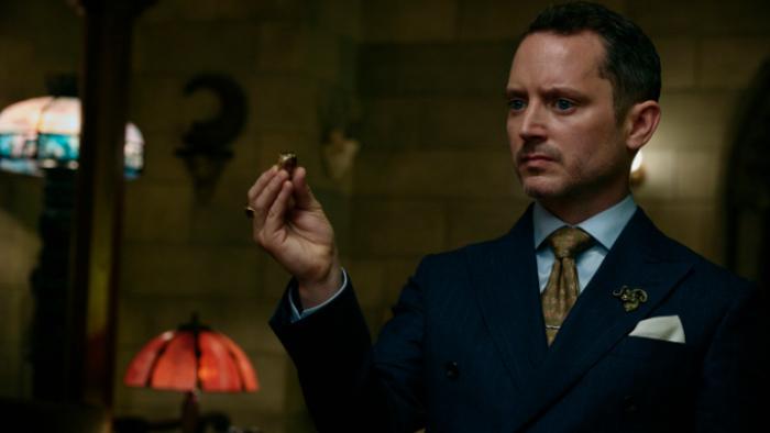 Ready or Not 2: Here I Come movie: The Lawyer stands in an elegantly appointed room in a suit, holding up a gold ring