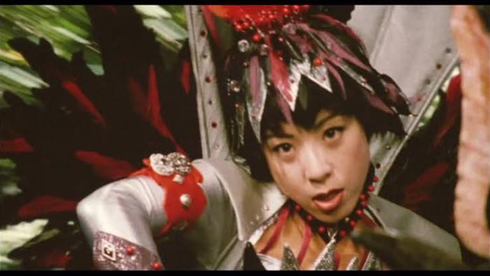 Rebirth of Mothra 2 Movie: Costumed person with feathered headdress in dynamic pose.