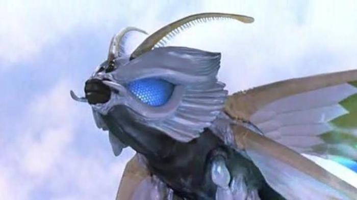 Rebirth of Mothra 2 Movie: Giant moth with blue eyes against a cloudy sky.