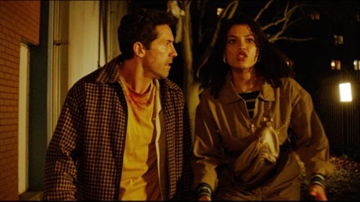 Reckless: A man and woman walk urgently at night, looking concerned