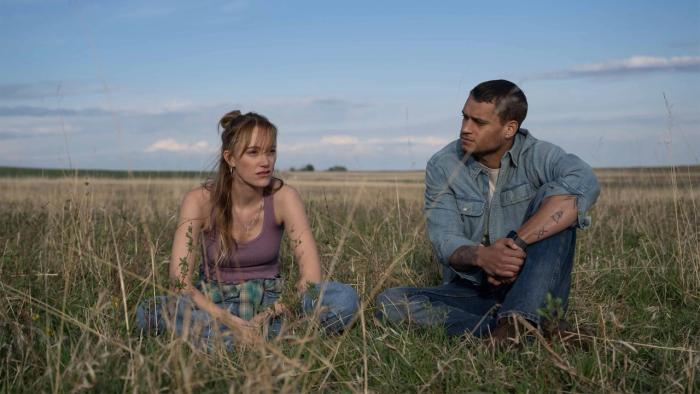 Reminders of Him movie: Maika Monroe and Tyriq Withers sit in the grass