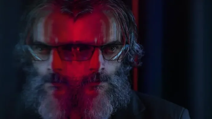 Rest in Peace movie: Argentinian bearded man in sunglasses has red mirror reflection of his face creating two images of him