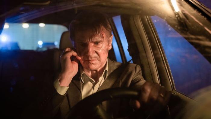 Retribution Movie: Matt Turner (Liam Neeson) is at the wheel of a car, looking fiercely angry and talking on a cell phone