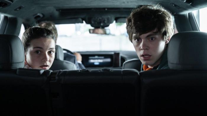 Retribution Movie: Matt's children, Emily (Lilly Aspell, left) and Zach (Jack Champion, right), are in the back seat, turning around, looking shocked at something behind them