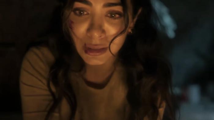 Rosario movie: Close-up of Rosario with visible facial scratches or wounds on their cheek