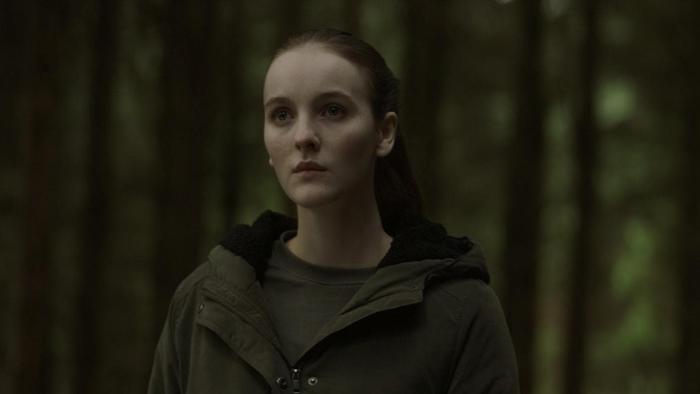 Rose Plays Julie: Woman stands with the woods behind her.