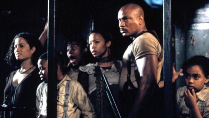 Rosewood Movie: Mann (Ving Rhames) and members of the African-American community.