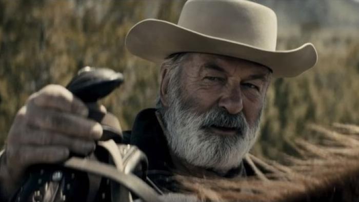 Rust Movie: Harland Rust (Alec Baldwin) adjusts a saddle