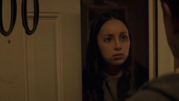 Ruthless: Melissa Diaz looks out from a partially open front door at a figure standing in front of her