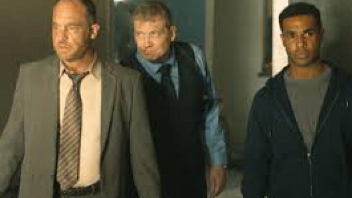Safe House Movie: 2 White men in suits and 1 Black man in hoodie walk
