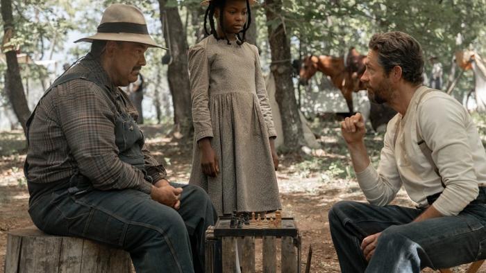Sarah's Oil movie: Naya Desir-Johnson stands talking to Zachary Levi and Mel Rodriguez