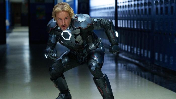 Secret Headquarters Movie: A man in a superhero suit crouches in a hallway filled with lockers