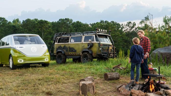 Secret Headquarters Movie: A man and a young boy stand in front on a camp fire next to two green vans