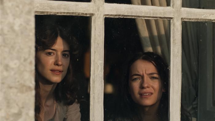 Sense and Sensibility: Two young women looking out a window, appearing curious and concerned