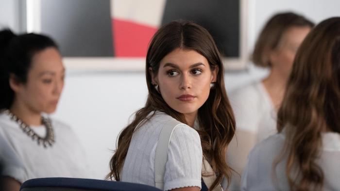 Shell Movie: Seated, Chloe (Kaia Gerber) turns around as if watching someone walk away