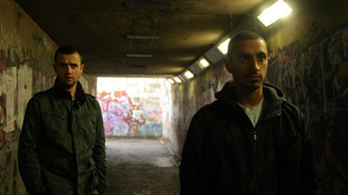 Shifty: A young White male and a young Asian male in an underpass