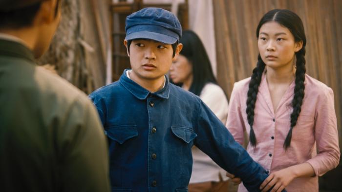 Sight Movie: A Chinese teen boy stands and protects a Chinese teen girl from a soldier