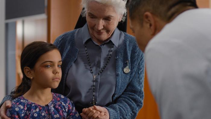 Sight Movie: A nun beams down at a blind Indian girl who stands in front of a doctor