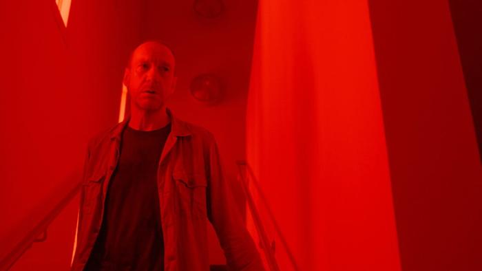 Signal One movie: David Thewlis walks down a red-lit stairwell