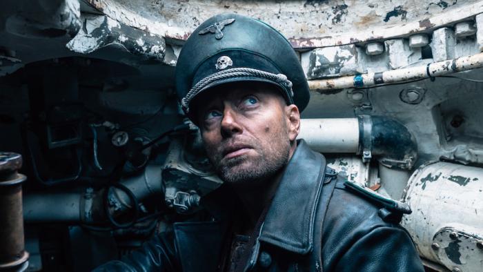 Sisu Movie: Nazi commander Helldorf, wearing a leather coat and officer's cap, is seen inside a tank