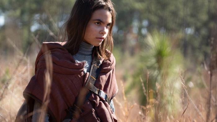 65 Movie: Koa looks exhausted and pensive during a pause from her long hike toward an escape pod