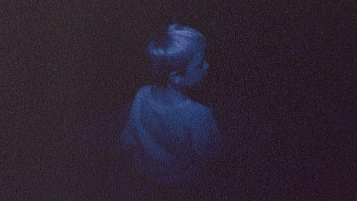 Skinamarink Movie: A child appears to be searching for something in the darkness