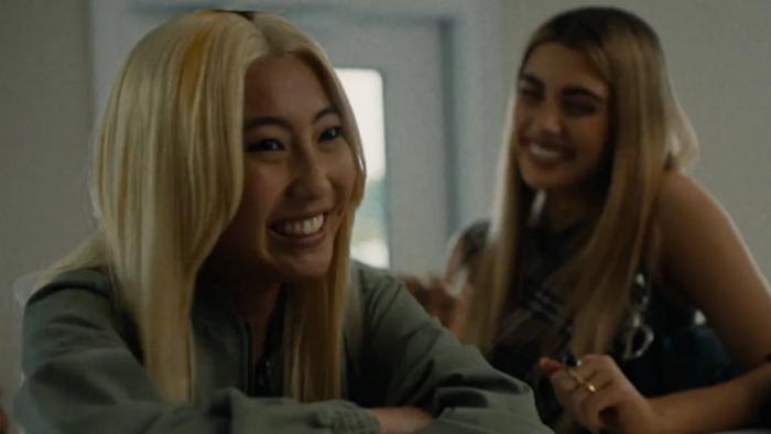 Slanted movie: Shirley Chen smiles at the counter of a nail salon with Amelie Zilbar looking on