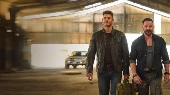 Sniper -- The Last Stand movie: Chad Michael Collins and Ryan Robbins walk through warehouse wearing black