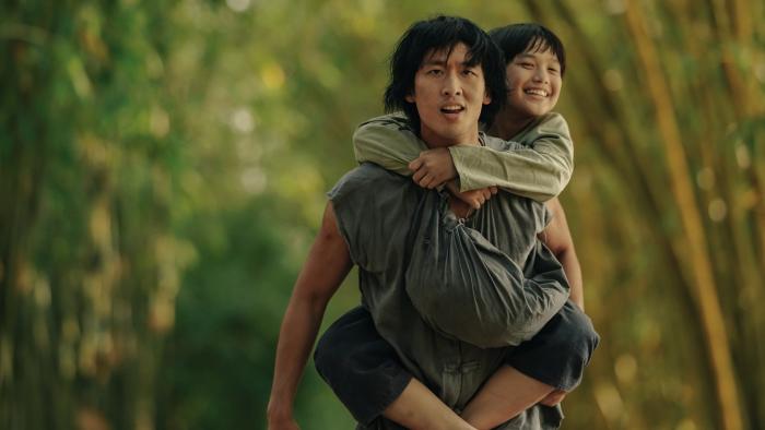 Song of the South: Tuan Tran carries Huynh Hao Khang on his back.