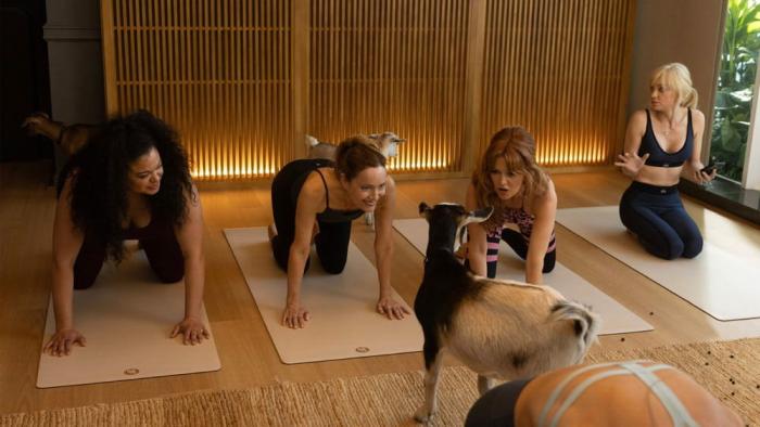 Spa Weekend movie: Michelle Buteau, Leslie Mann, Isla Fisher, and Anna Faris kneel on mats for goat yoga