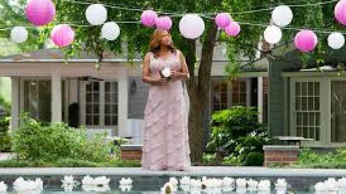 Steel Magnolias: Queen Latifah in pink dress by pool, surrounded by pink and white balloons.