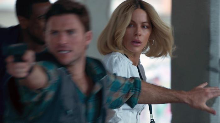 Stolen Girl movie: Scott Eastwood aims a gun as Kate Beckinsale turns around