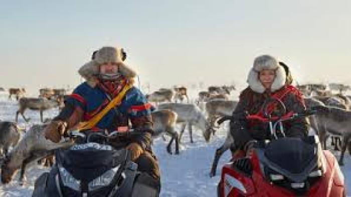 Stolen: Bundled up people with reindeer