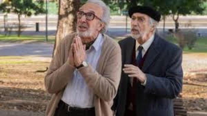 Strangers in the Park Movie: Two older men in park, one making prayer gesture