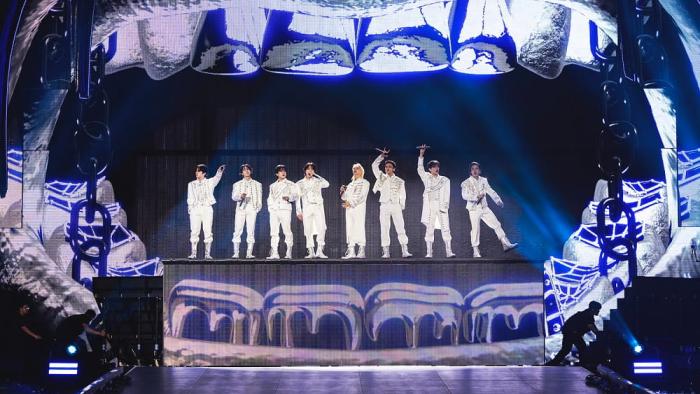 Stray Kids: The dominATE Experience movie: The Stray Kids sing on stage inside an open mouth projection