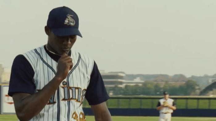 Sugar movie: Algenis Perez Soto holds his cross necklace in his hand as he walks onto the baseball field