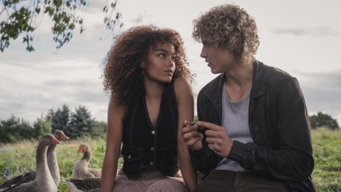 The Hunger Games: Sunrise on the Reaping movie: Joseph Zada and Whitney Peak sit together in a meadow