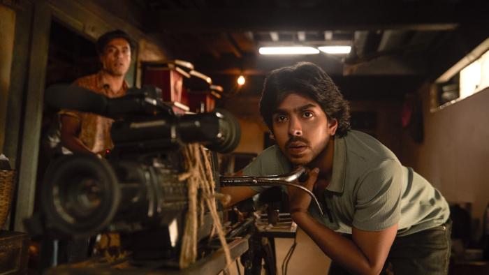 Superboys of Malegaon: An Indian man works a camera while another looks on
