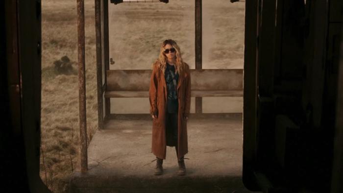 Supergirl Movie: Milly Alcock waits at an abandoned bus station