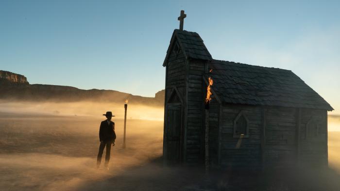 Surrounded Movie: Mo Washington (Letitia Wright) stands on a dusty plain outside a small church
