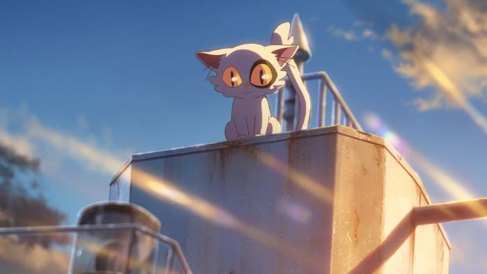 Suzume movie: Daijin the cat sits on the top of a ship, while the sun shines brightly behind him making his white fur glow.