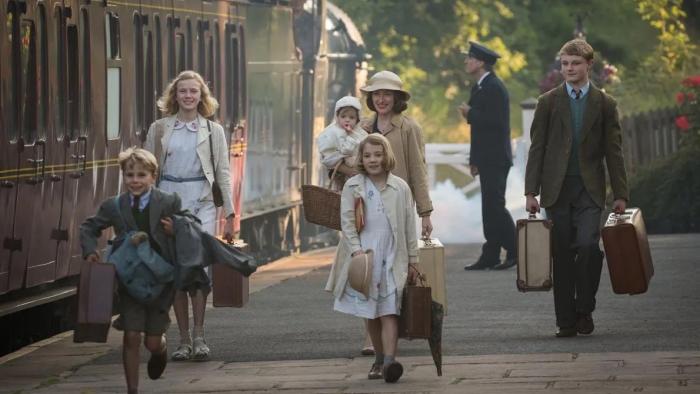 Swallows and Amazons: A mom and five children on a 1930s train platform