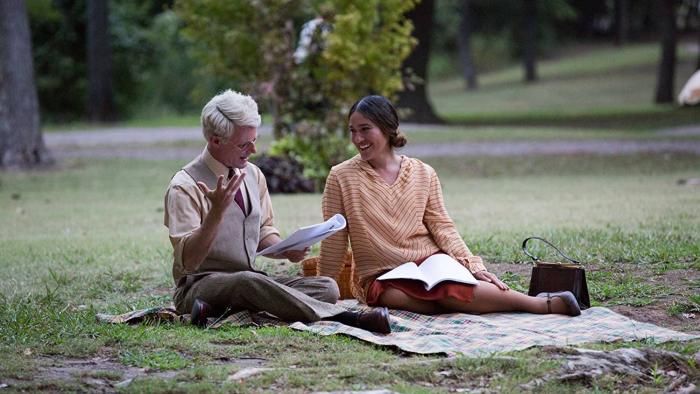 Te Ata Movie: Te Ata sits on a picnic blanket outside, smiling at an older White man with white hair