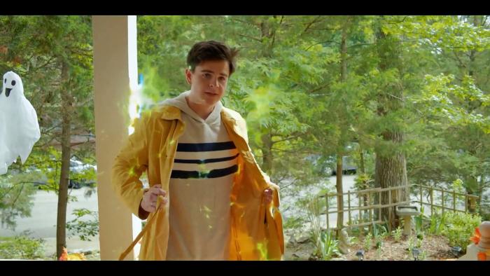 The Magician's Raincoat: A boy tries on a yellow raincoat